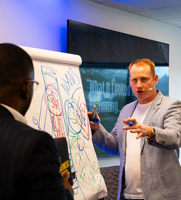 Adam Stott coaching at a flipchart